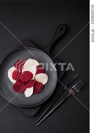 Delicious fresh mozzarella and boiled beets cut into slices 100609556