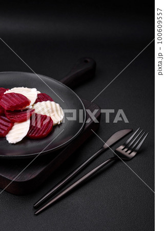 Delicious fresh mozzarella and boiled beets cut into slices 100609557