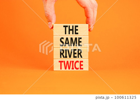 The same river twice symbol. Concept words The same river twice on wooden block. Beautiful orange table orange background. Motivational business the same river twice concept. Copy space. The same river twice symbol. Concept words The same river twice on wooden block. Beautiful orange table orange background. Motivational business the same river twice concept. Copy space. 100611325