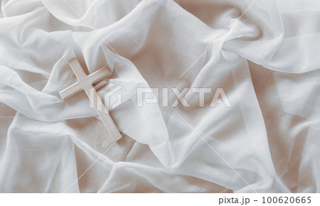 Good Friday and Holy week concept - A religious cross on white fabric background. Good Friday and Holy week concept - A religious cross on white fabric background. 100620665