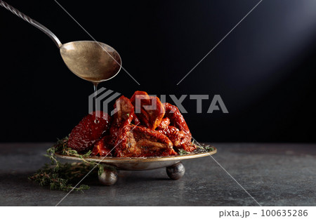Sun-dried tomatoes with thyme in olive oil. Sun-dried tomatoes with thyme in olive oil. 100635286