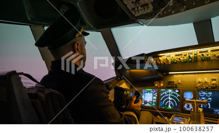 A man is studying to be a pilot in an aircraft simulator.  100638257
