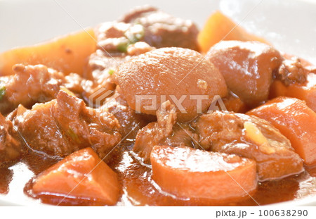 boiled pork leg with carrot in sweet red gravy sauce stew on plate boiled pork leg with carrot in sweet red gravy sauce stew on plate 100638290