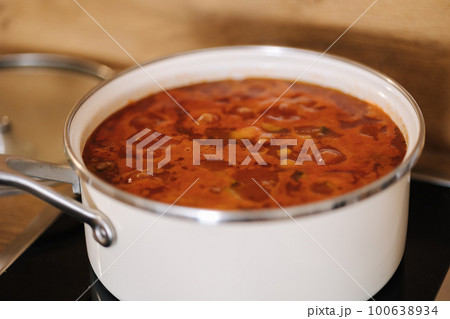 Mexican traditional dish is boiling in white pans. Home made food concept. Spicy food 100638934
