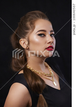 portrait shot of a young Ukrainian woman on the background, after make-up and hairstyle, for clothing advertising portrait shot of a young Ukrainian woman on the background, after make-up and hairstyle, for clothing advertising 100640507