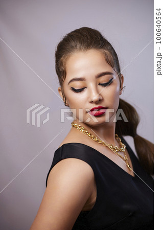 portrait shot of a young Ukrainian woman on the background, after make-up and hairstyle, for clothing advertising portrait shot of a young Ukrainian woman on the background, after make-up and hairstyle, for clothing advertising 100640564
