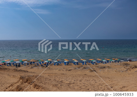 The northern part of the Greek island of Corfu with a sandy beach. Umbrellas and chairs on the beachfront 100645933