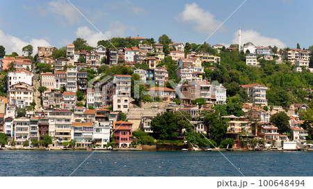 Green mountains of the European side of Bosphorus strait, with traditional houses and dense trees in a summer day Green mountains of the European side of Bosphorus strait, with traditional houses and dense trees in a summer day 100648494