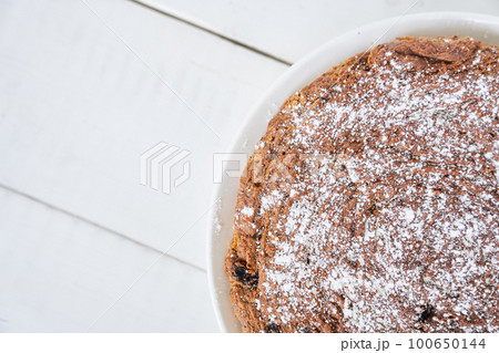 Top view of a piece of carrot and raisin pie. The pie is gluten-free, milk-free and egg-free. Selective focus, space for text. Diet dessert. The concept of healthy eating. High quality photo 100650144