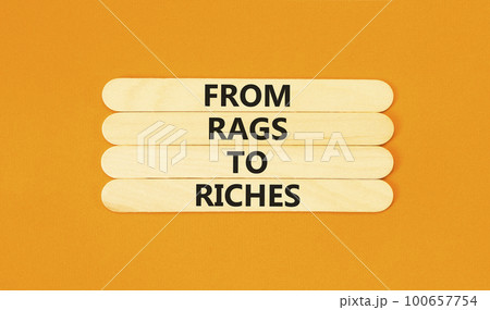 Rags or riches symbol. Concept words From rags to riches on wooden stick. Beautiful orange table orange background. Business rags or riches concept. Copy space. Rags or riches symbol. Concept words From rags to riches on wooden stick. Beautiful orange table orange background. Business rags or riches concept. Copy space. 100657754