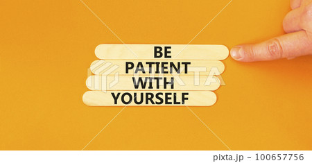Patient with yourself symbol. Concept words Be patient with yourself on wooden stick. Beautiful orange table orange background. Businessman hand. Business patient with yourself concept. Copy space. Patient with yourself symbol. Concept words Be patient with yourself on wooden stick. Beautiful orange table orange background. Businessman hand. Business patient with yourself concept. Copy space. 100657756