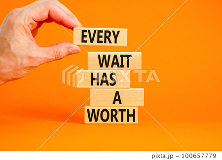 Every wait has a worth symbol. Concept words Every wait has a worth on wooden blocks. Beautiful orange table orange background. Businessman hand. Business Every wait has a worth concept. Copy space. 100657779