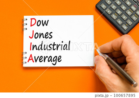 DJIA Dow Jones industrial average symbol. Concept words DJIA Dow Jones industrial average on white note on beautiful orange background. Business DJIA Dow Jones industrial average concept. Copy space 100657895