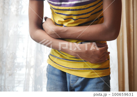 young man suffering stomach pain close up. young man suffering stomach pain close up. 100659631