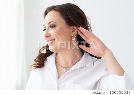 Fashionable and stylish woman in trendy jewelry big earrings . Fashion look beauty and style. Natural makeup and easy styling Fashionable and stylish woman in trendy jewelry big earrings . Fashion look beauty and style. Natural makeup and easy styling 100659632