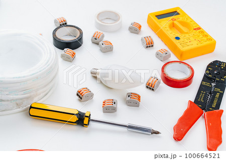 working tools for an electrician on a white background. working tools for an electrician on a white background. 100664521