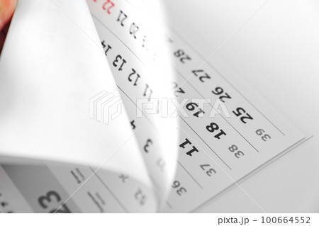 flipping through the pages of the flip calendar.  100664552