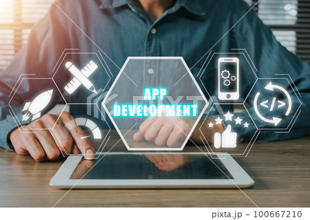 App development concept, Person hand using digital tablet with app development icon on virtual screen background, Designing application for mobile phone. 100667210
