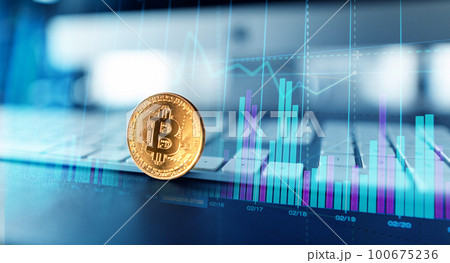 Golden bitcoins. Cryptocurrency on computer desk and Double Exposure chart 100675236