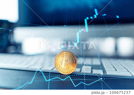 Golden bitcoins. Cryptocurrency on computer desk and Double Exposure chart Golden bitcoins. Cryptocurrency on computer desk and Double Exposure chart 100675237
