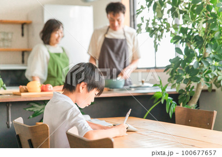 家のダイニング・リビング・居間で宿題・勉強する小学生低学年の男の子 100677657