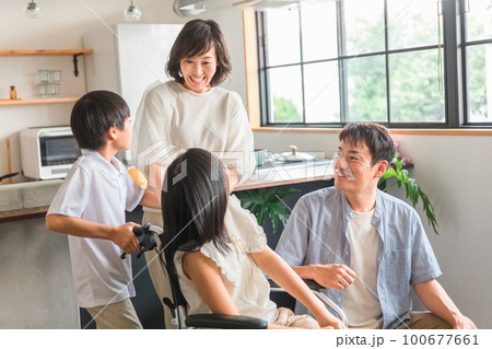 車椅子に乗る女の子と笑顔の家族・ファミリー(車いす体験・退院・バリアフリー) 車椅子に乗る女の子と笑顔の家族・ファミリー(車いす体験・退院・バリアフリー) 100677661