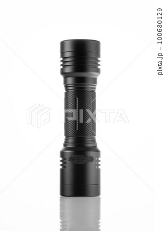 LED black flashlight close-up on white background, trace of bright light LED black flashlight close-up on white background, trace of bright light 100680129