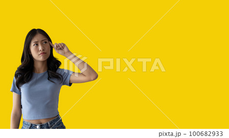 Young Asian woman thinking hard or planning to do something, Overthinking or worrying, Have a headache, Migraine, Stress, Free space for advertising or promoting products, Copy space, Enter text. Young Asian woman thinking hard or planning to do something, Overthinking or worrying, Have a headache, Migraine, Stress, Free space for advertising or promoting products, Copy space, Enter text. 100682933
