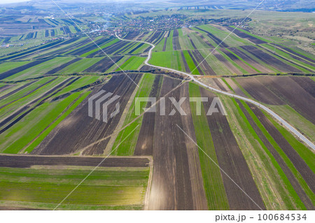 Aerial drone view of agricultural fields of plowed crops Aerial drone view of agricultural fields of plowed crops 100684534