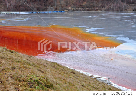 Pollution of a lake with contaminated water from a gold mine. Pollution of a lake with contaminated water from a gold mine. 100685419
