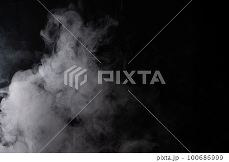 Cloud of white smoke on a black background closeup 100686999