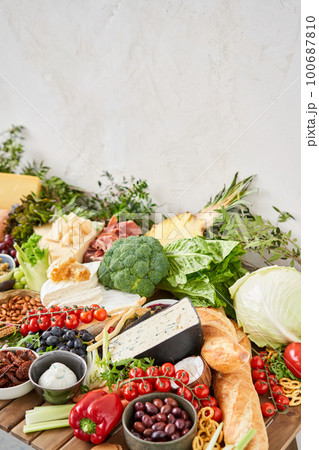 Table full of mediterranean appetizers, tapas or antipasto. Assorted Italian food set. Delicious snack on party or picnic time. Meat and cheese. Italian style banquet.  100687810