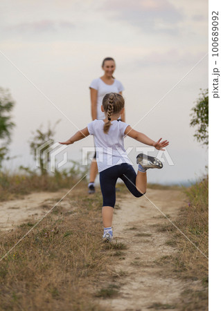mother and daughter walking 100689092