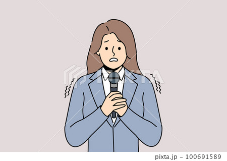 Anxious woman scared talking in microphone  100691589