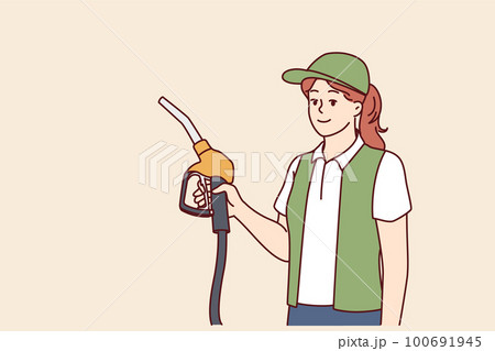 Woman serving customers at refueling station holding nozzles for refilling oil tank Woman serving customers at refueling station holding nozzles for refilling oil tank 100691945