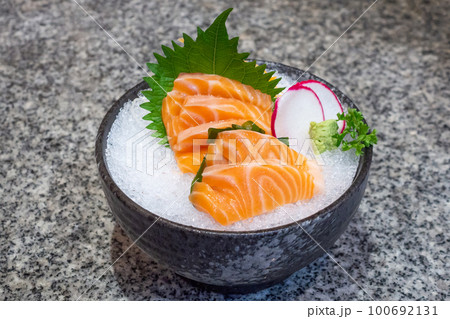 salmon sashimi on ice in black bowl japanese food 100692131