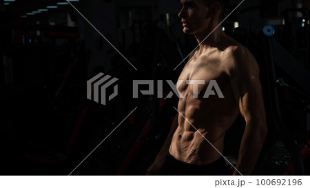 Shirtless man with sculpted body in the gym. Shirtless man with sculpted body in the gym. 100692196