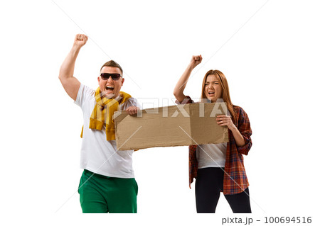 Image of young man and woman holding cardboard posters with empty space for text over white background. Protesting Image of young man and woman holding cardboard posters with empty space for text over white background. Protesting 100694516