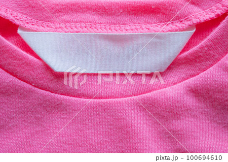 blank laundry care clothes label on pink shirt blank laundry care clothes label on pink shirt 100694610