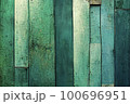 Texture background made up of old, uneven boards with a range of dark green colors and shades. The surface of the boards appears worn and weathered, with visible cracks and natural defects. 100696951