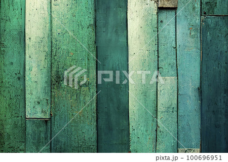 Texture background made up of old, uneven boards with a range of dark green colors and shades. The surface of the boards appears worn and weathered, with visible cracks and natural defects. 100696951