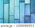 Background made of old, light blue boards. The weathered texture and faded color of the boards give a sense of age and history. The simplicity of the image creates a calm and peaceful atmosphere 100696953
