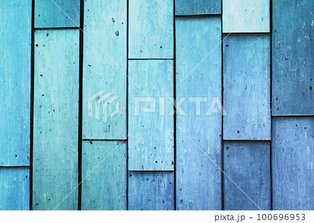 Background made of old, light blue boards. The weathered texture and faded color of the boards give a sense of age and history. The simplicity of the image creates a calm and peaceful atmosphere Background made of old, light blue boards. The weathered texture and faded color of the boards give a sense of age and history. The simplicity of the image creates a calm and peaceful atmosphere 100696953