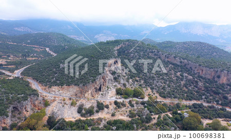 Aerial drone view of mountains ridges and country road. Picturesque gorge view from above. Aerial drone view of mountains ridges and country road. Picturesque gorge view from above. 100698381