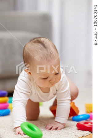 baby girl playing with colorful toy blocks baby girl playing with colorful toy blocks 100700141