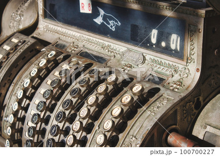 Close-up of an old antique metallic commercial cash register Close-up of an old antique metallic commercial cash register 100700227