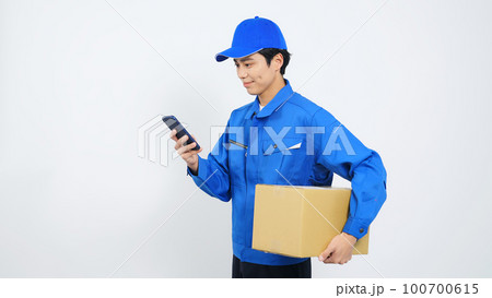 段ボールを持ってスマホを使う作業員　宅配便　デリバリースタッフ 100700615
