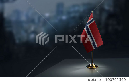 Small flags of the Norway on an abstract blurry background 100701560