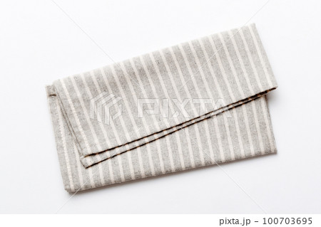 top view with gray kitchen napkin isolated on table background. Folded cloth for mockup with copy space, Flat lay. Minimal style top view with gray kitchen napkin isolated on table background. Folded cloth for mockup with copy space, Flat lay. Minimal style 100703695