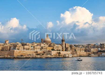 Valletta city skyline with a blue sky with big fluffy dramatic clouds in the background Valletta city skyline with a blue sky with big fluffy dramatic clouds in the background 100705743